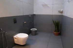 Elegant and modern bathroom at Kappad Beach House by Kisah Stays, featuring sleek fixtures, a spacious vanity, and a luxurious shower area. Designed for comfort and relaxation, this well-appointed space offers a refreshing retreat during your beachfront stay in Kozhikode, Kerala.