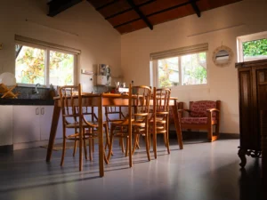 Spacious kitchen and dining area at Kappad Beach House by Kisah Stays, featuring a fully equipped modern kitchen, elegant dining table, and stylish interiors. Designed for convenience and comfort, this space is perfect for preparing and enjoying delicious meals while experiencing a luxurious beachfront stay in Kozhikode, Kerala.