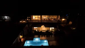 Aerial night time view of Kappad Beach House by Kisah Stays, a luxury beachfront villa in Kozhikode, Kerala. Captured by a drone, the image showcases the villa’s private pool, lush greenery, and stunning coastal surroundings, with the Arabian Sea stretching into the horizon. A perfect retreat for a serene and scenic getaway